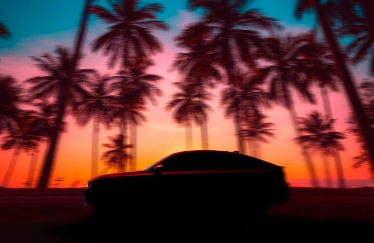 A 2022 Honda Civic Hatchback on the road in silhouette.