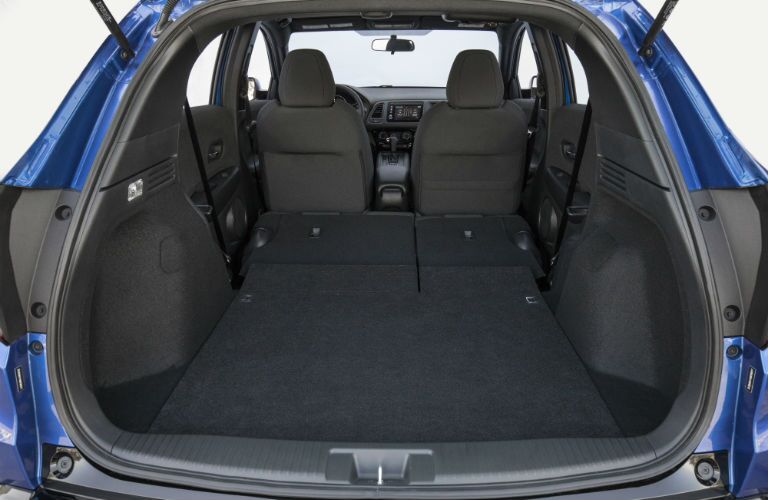An interior photo showing the rear seats folded down for maximum cargo capacity.