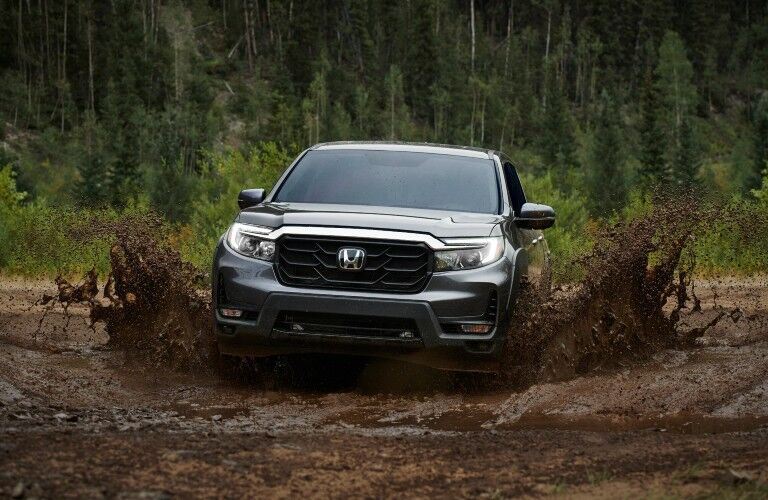 A photo of the 2021 Honda Ridgeline going through the mud.