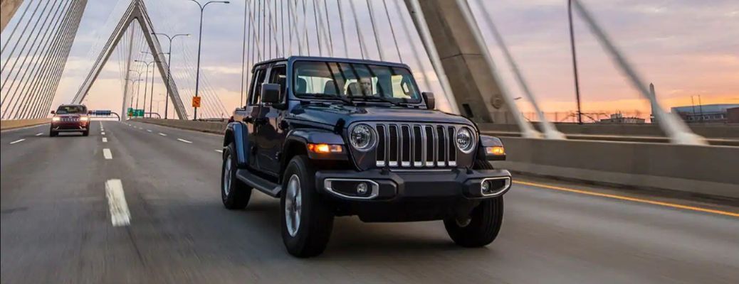 Front view of the 2023 Jeep Wrangler on road Front view of the 2023 Jeep Wrangler on road