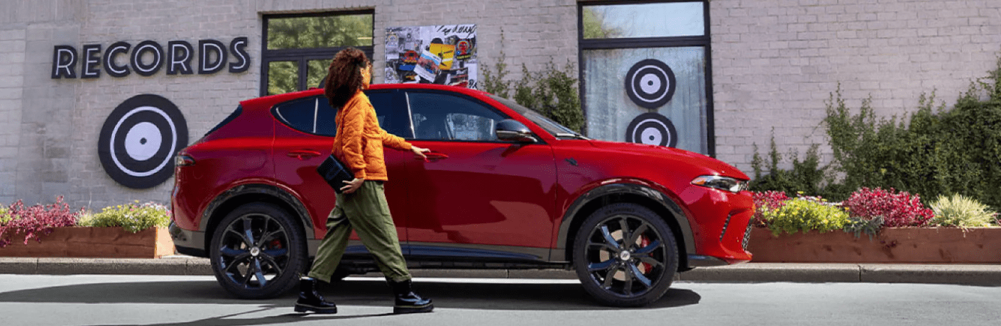 A woman near the 2024 Dodge Hornet A woman near the 2024 Dodge Hornet