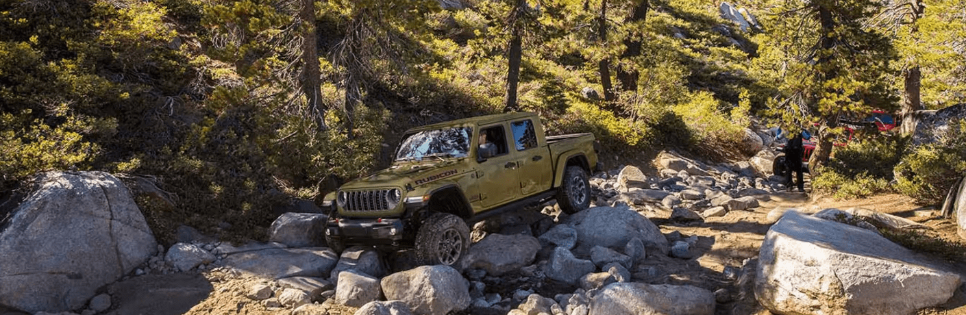 Side view of the 2025 Jeep Gladiator on a rough terrain Side view of the 2025 Jeep Gladiator on a rough terrain