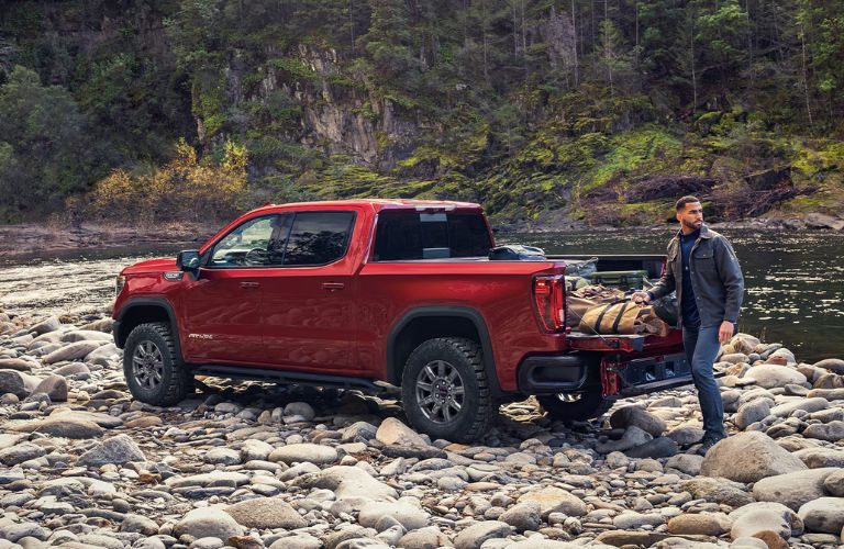 A man loading bags on the 2026 GMC Sierra 1500