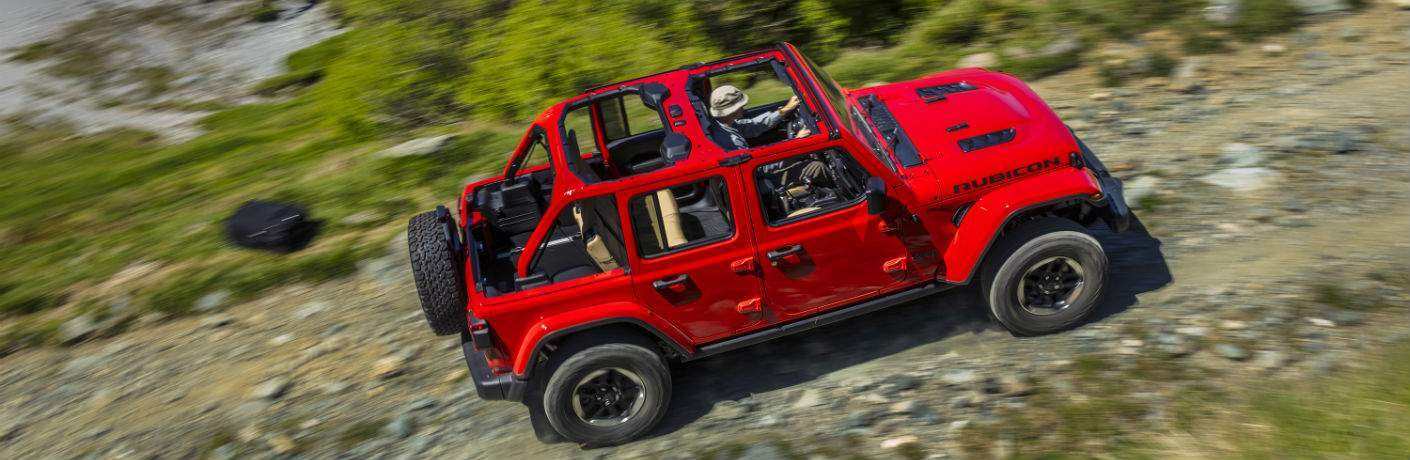 An overhead view of a red 2018 Jeep Wrangler on a rocky off-road trail
