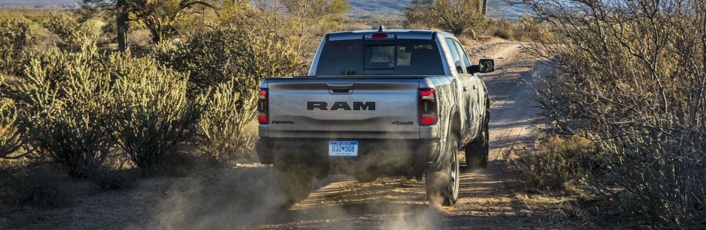 A rear photo of the 2019 Ram 1500 driving away from the camera.