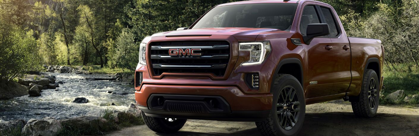 A front left quarter photo of the 2019 GMC Sierra Elevation Edition parked by a creek.