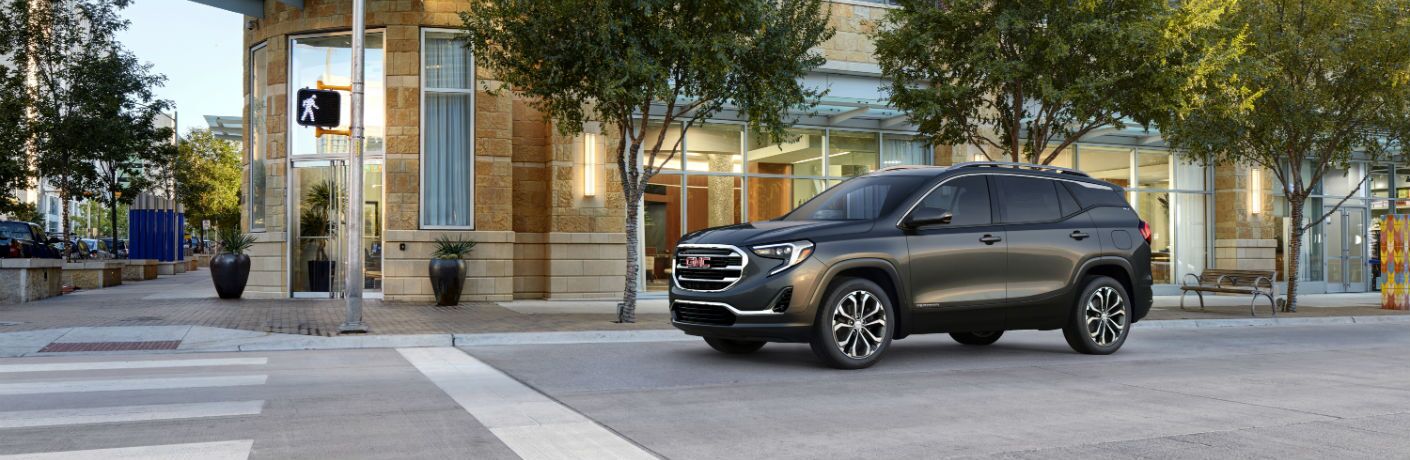A left profile photo of the 2019 GMC Terrain at a stop light.