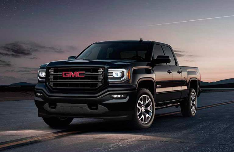 Black GMC Sierra in the desert Billion Auto Group has deep rebates available for the truck in October