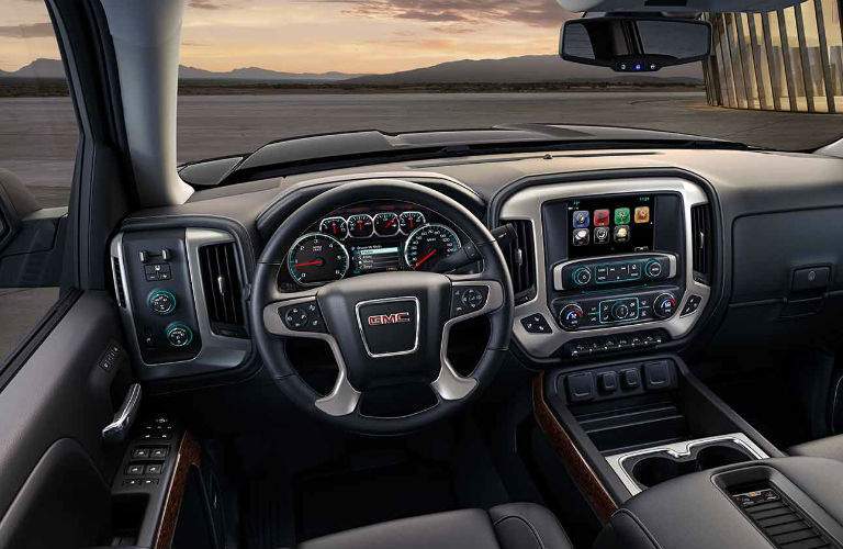 2017 GMC Sierra interior showing gauge cluster and infotainment system. These features are available with the selected inventory for the Billion Auto Group sale