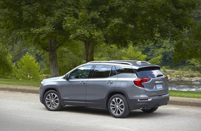 A left profile view of a 2018 GMC Terrain parked on the side of the road