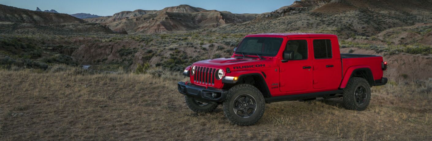 A left profile photo of the 2020 Jeep Gladiator parked in the mountains.