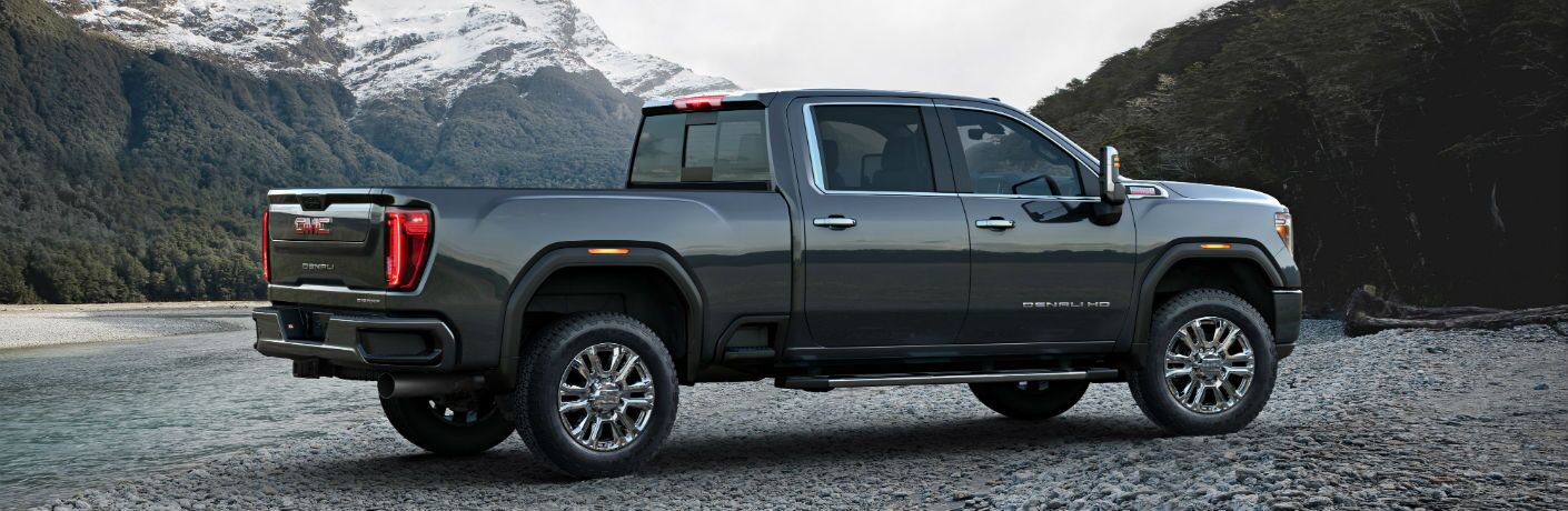 A right profile photo of the 2020 GMC Sierra 2500HD parked by a river.