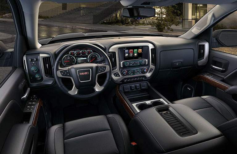 An interior view of the driver's seat and dashboard in the 2018 GMC Sierra