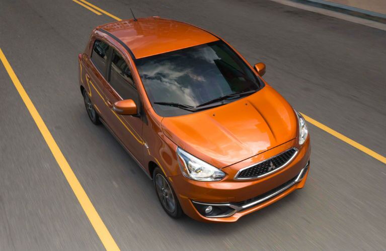 2018 Mitsubishi Mirage in orange driving down a road