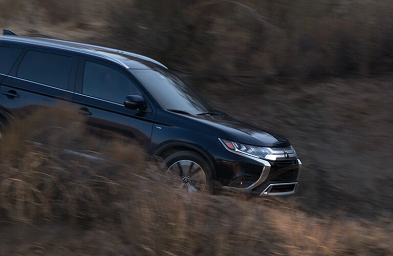 Blue 2019 Mitsubishi Outlander driving down hill