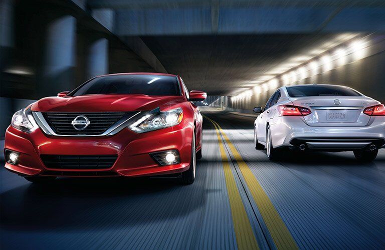 Red and Silver 2017 Nissna Altimas Passing in Opposite Directions