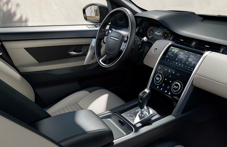 Grey and white dashboard and front seats in 2020 Land Rover Discovery Sport