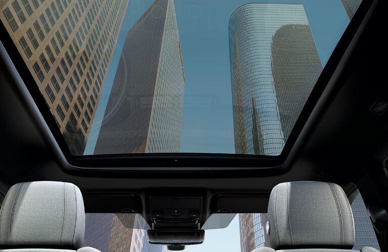 View of skyscrapers through the moonroof of a 2020 Land Rover Range Rover Evoque