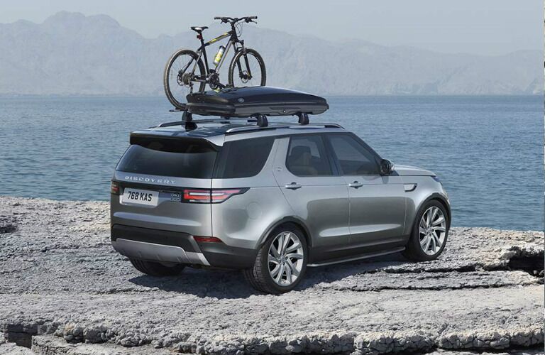 Silver 2020 Land Rover Discovery parked on a cliff next to the ocean
