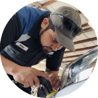 Cocoa Hyundai service center man buffing white Hyundai
