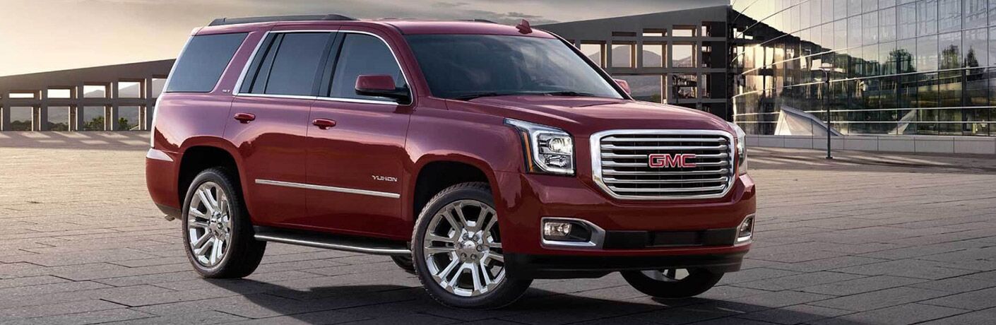 2017 GMC Yukon parked near a large facility