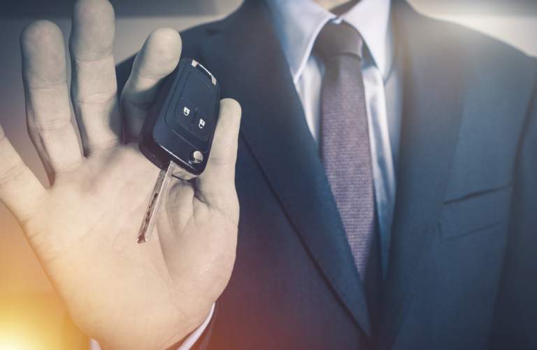 man showing car keys to the camera