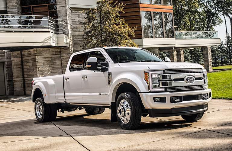 2018 Ford f-250 Super Duty in White parked outside of a beautiful house