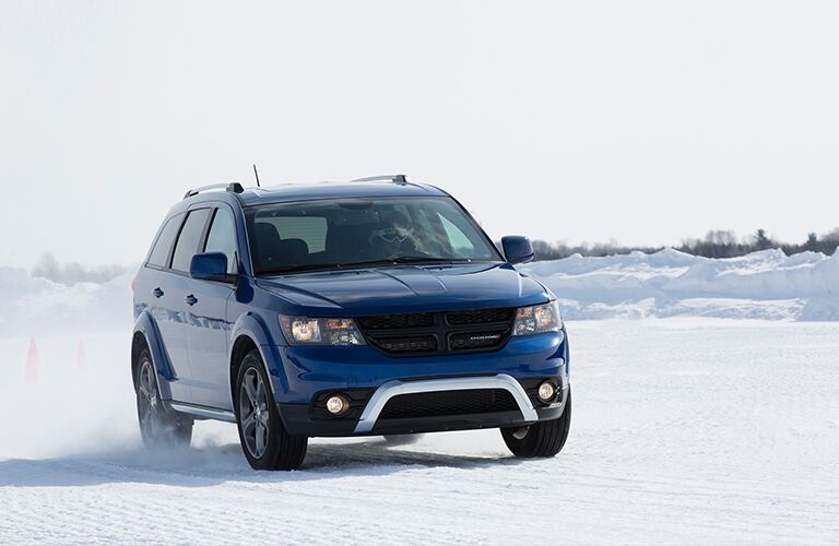 blue 2018 Dodge Journey driving in the snow