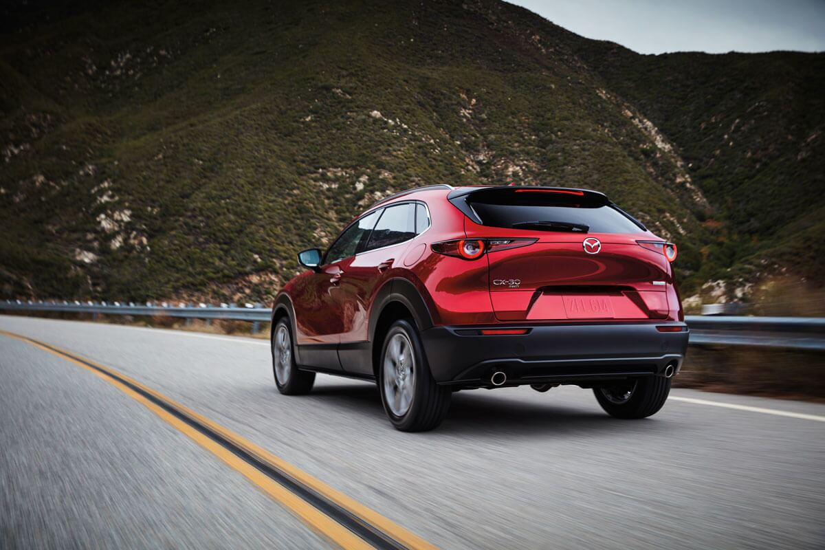 Mazda CX-30 driving down a rural highway near Edinburg, TX