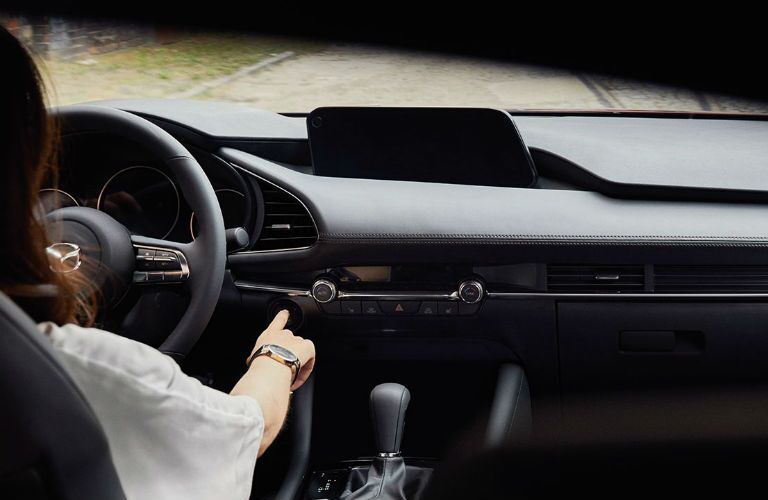 A photo of a driver in the driver's seat of the 2020 Mazda3 Sedan.