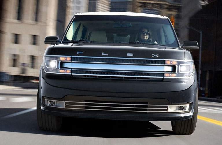 black ford flex on highway, grille view