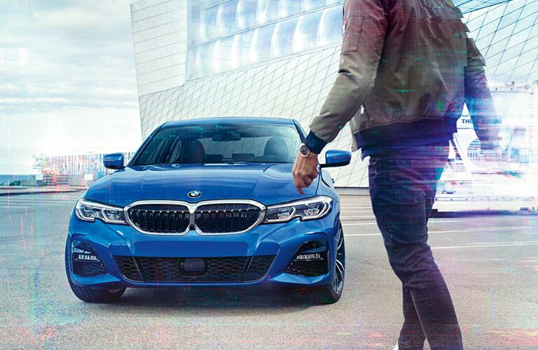 man approaching parked 2019 BMW 3 Series