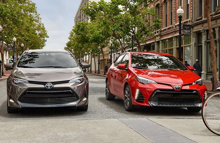 Two 2019 Toyota Corolla models parked side by side on the street