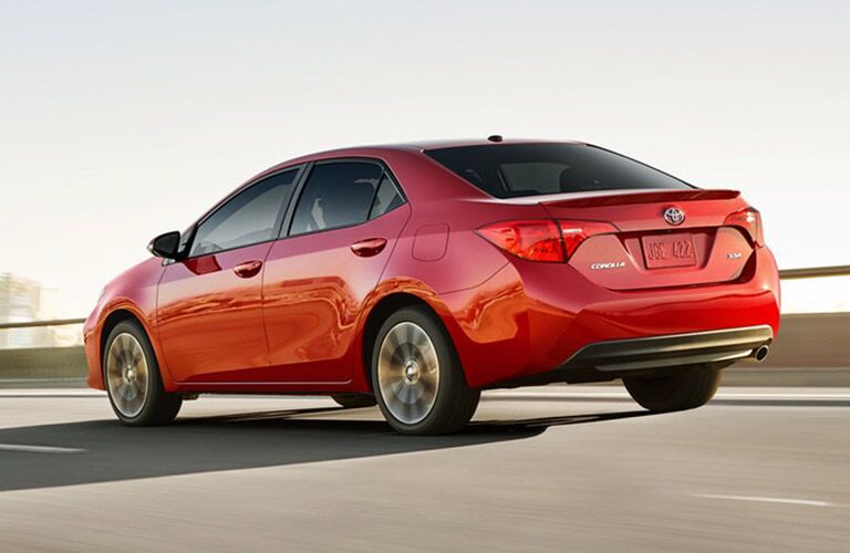 2019 Toyota Corolla exterior rear quarter view as it drives away on a highway road
