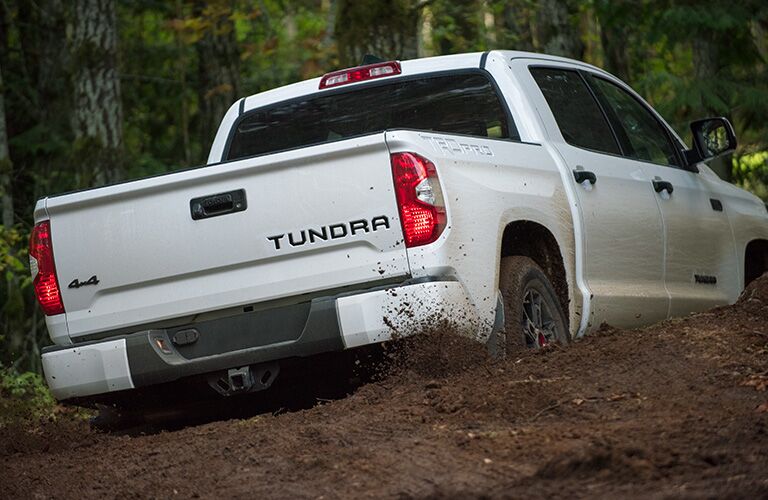 rear view of 2020 Toyota Tundra driving through mud