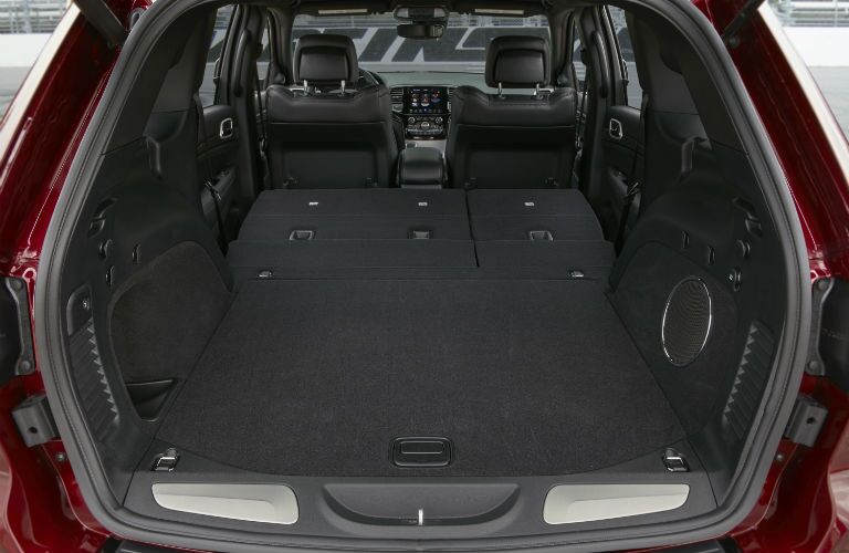 A photo of the cargo area in the back of a used Jeep vehicle for sale.
