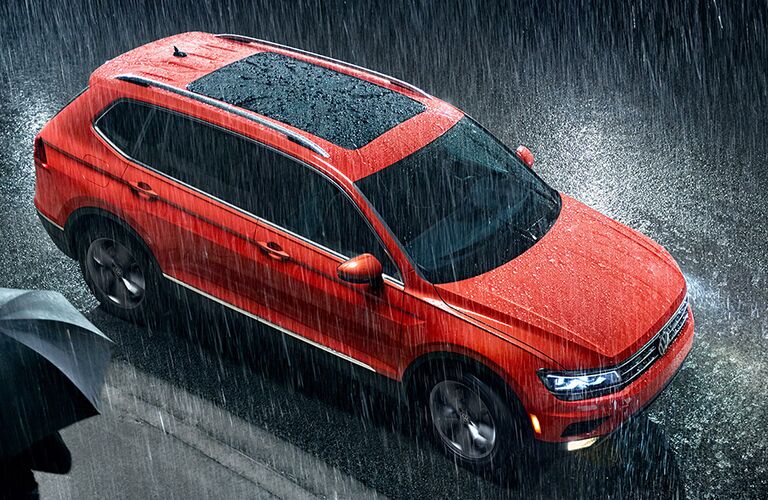 A photo of a VW crossover SUV in the rain on the road.