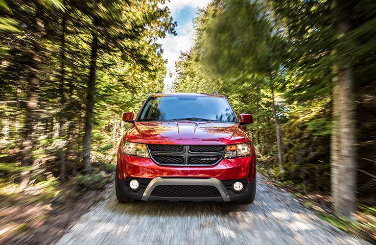 red dodge journey driving in woods