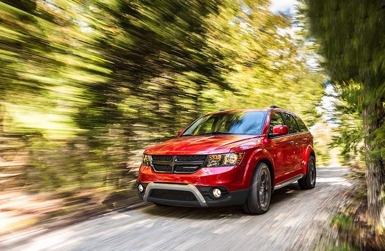 red dodge journey in woods