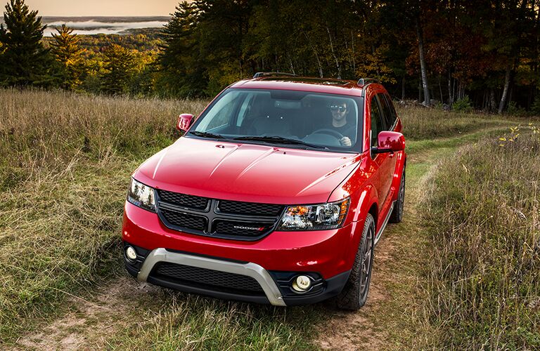 red dodge journey in woods
