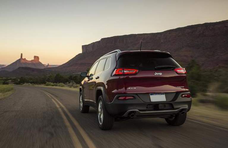 red jeep cherokee rear on highway