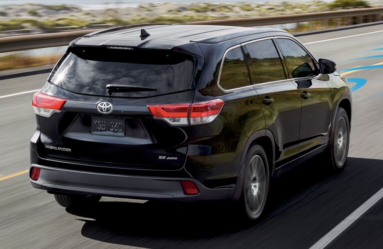 Black 2018 Toyota Highlander Rear Exterior on a Highway