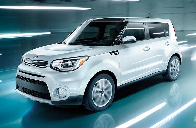 front and side view of white 2019 kia soul against blue background