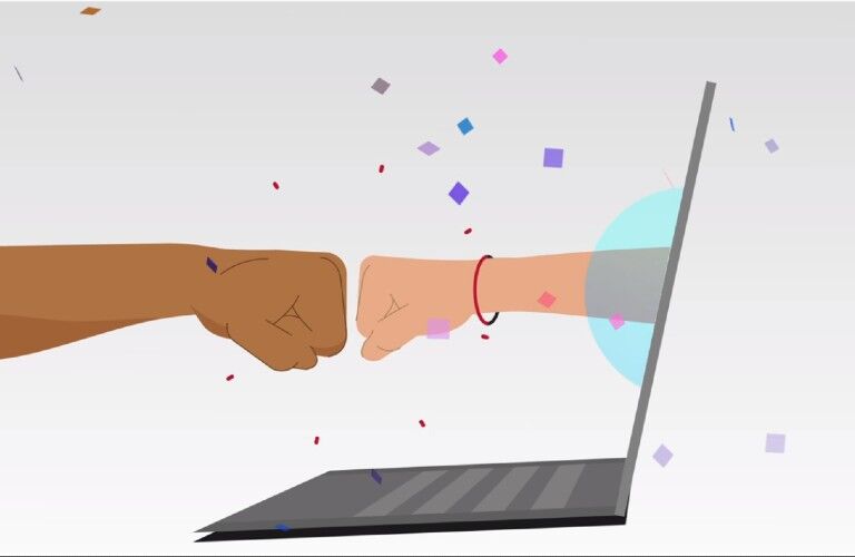 hand out of laptop fist bumping another hand with confetti falling