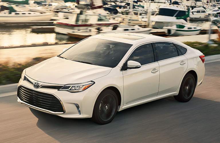 White Toyota Avalon driving in front of boat launch site