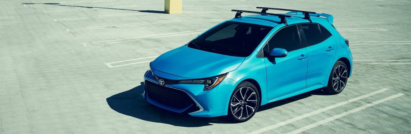 Blue 2019 Toyota Corolla Hatchback parked in parking lot in daytime