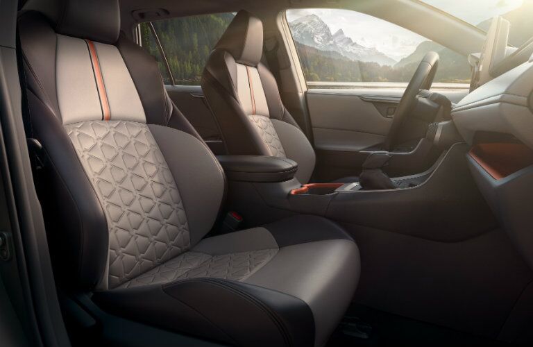 Front two seats of 2019 Toyota RAV4 with center console and steering wheel in frame