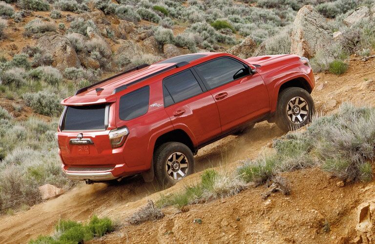 Red 2020 Toyota 4Runner driving up a hill