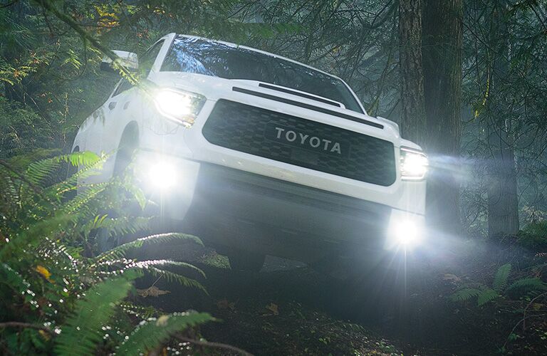 White 2020 Toyota Tundra driving through a forest