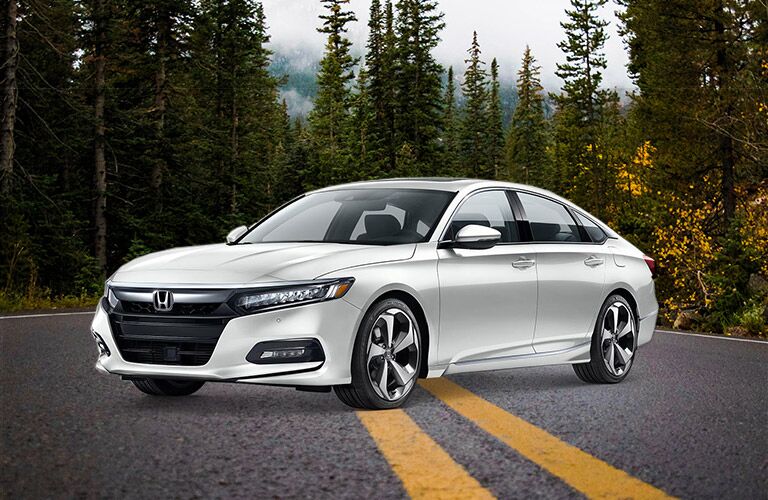 white honda accord parked on wooded road